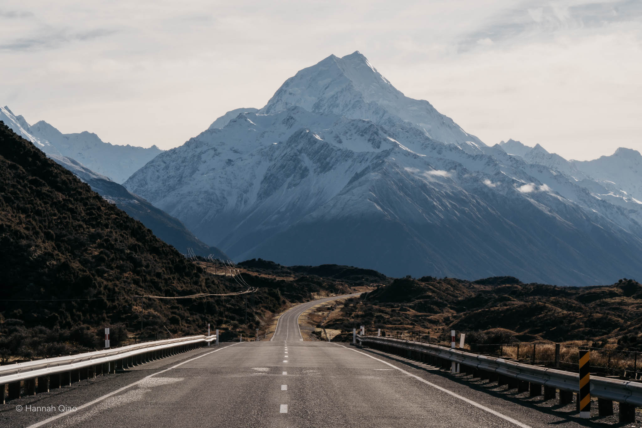 Photo of a road leading to a large snowy mountain