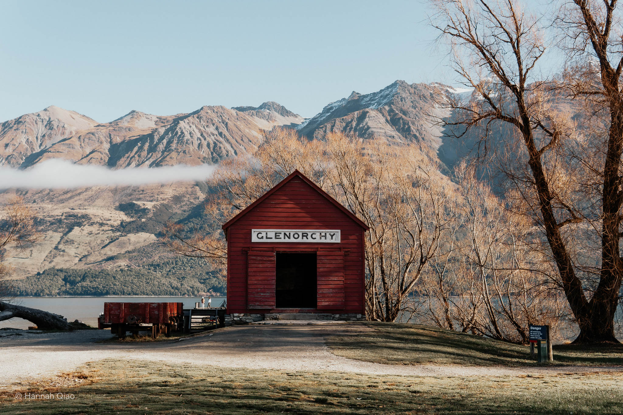 Photo of a red shed with "Glenorchy" written on it, mountains in the background