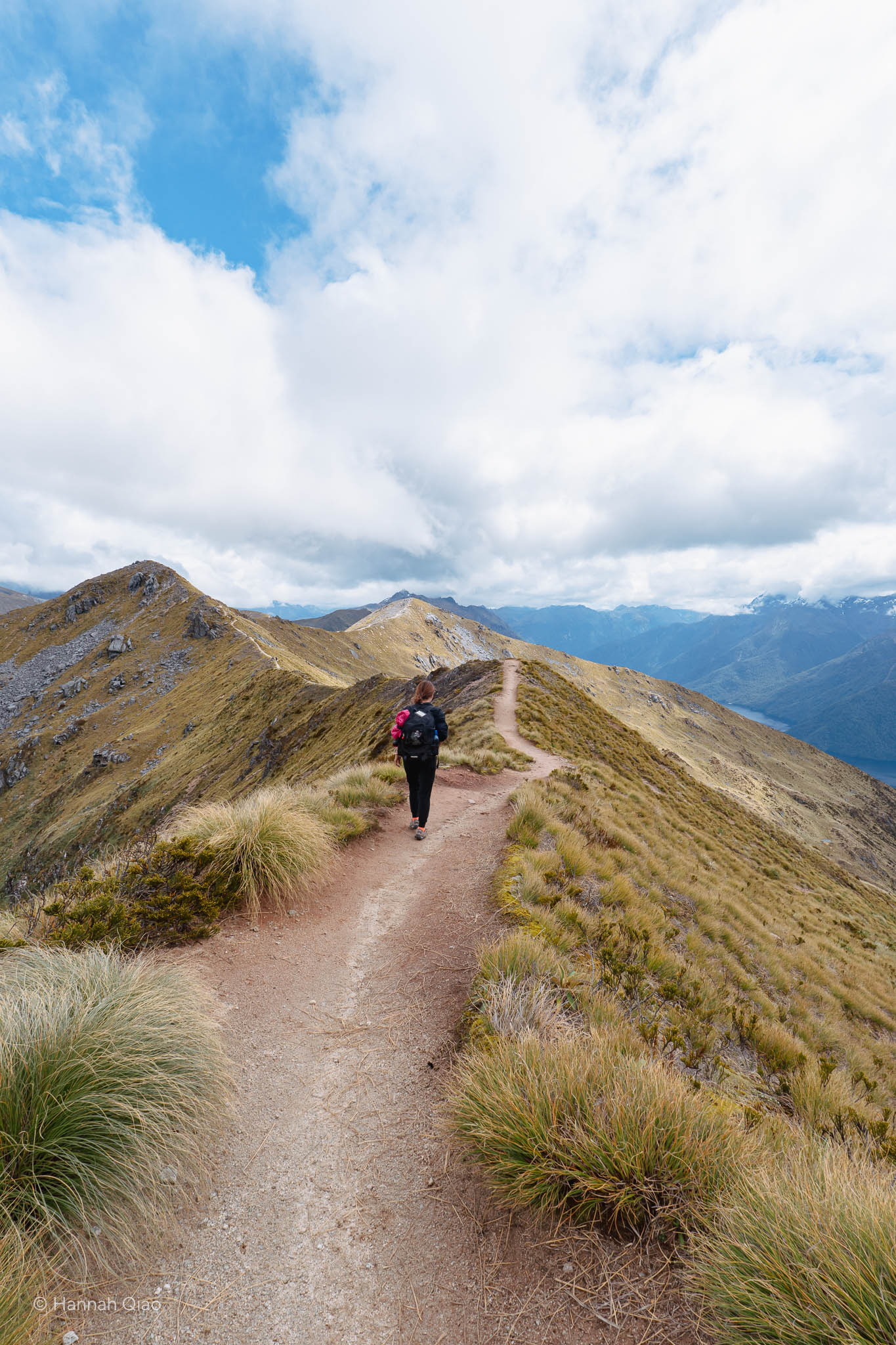 Photo of a woman hiking on a ridge line