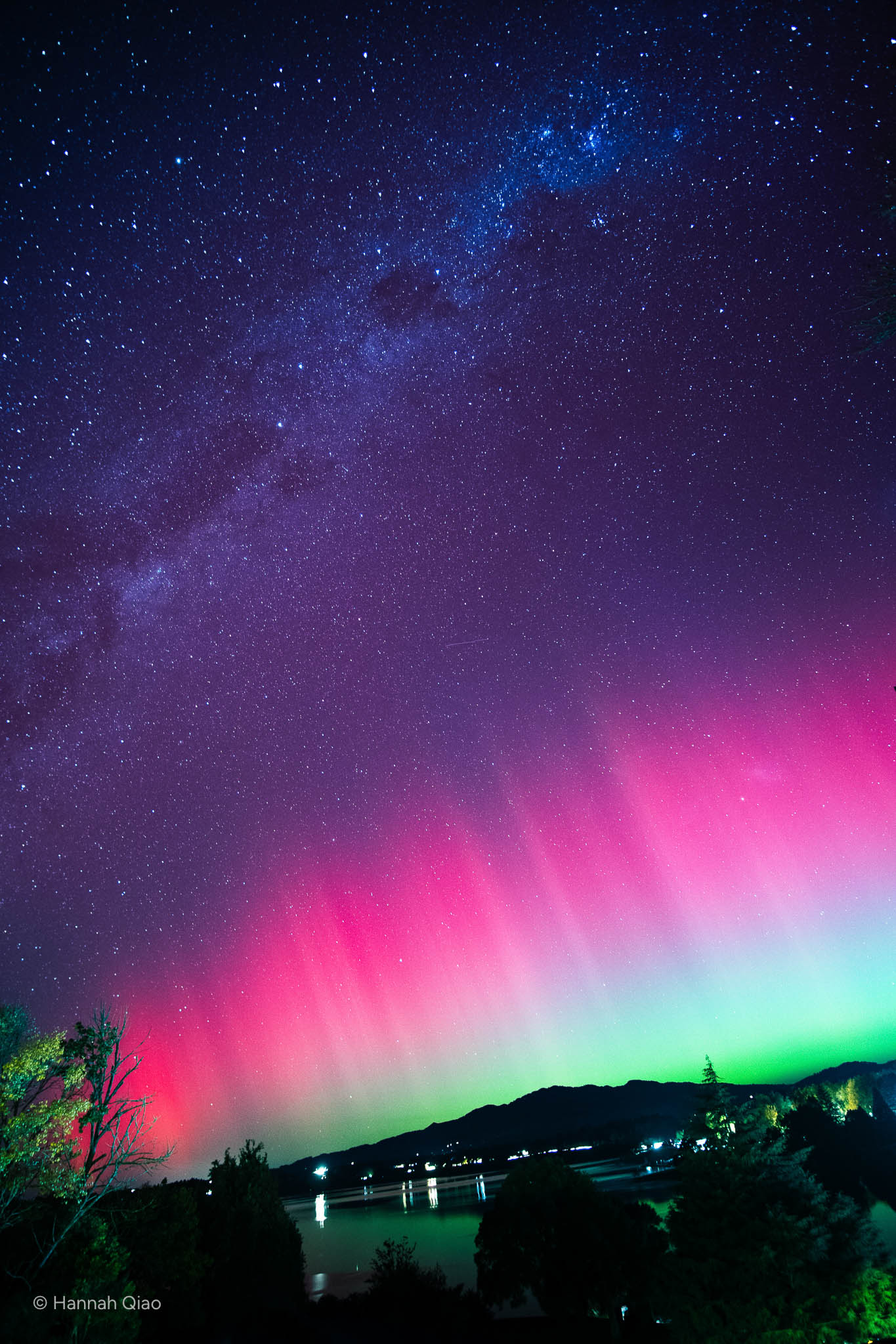 Photo of the southern lights in pink and green with the milky way in the background